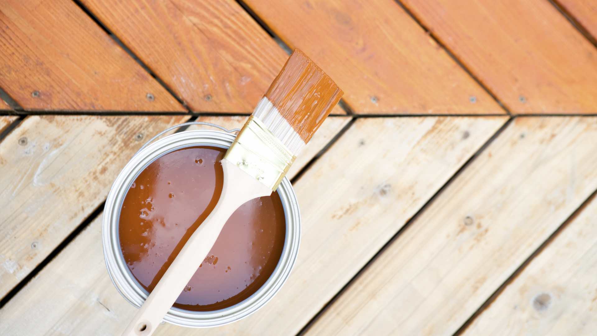 A paint can with a paint brush in it