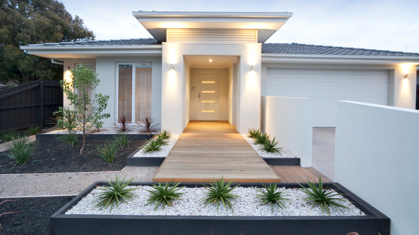 A white house with a wooden walkway leading to it