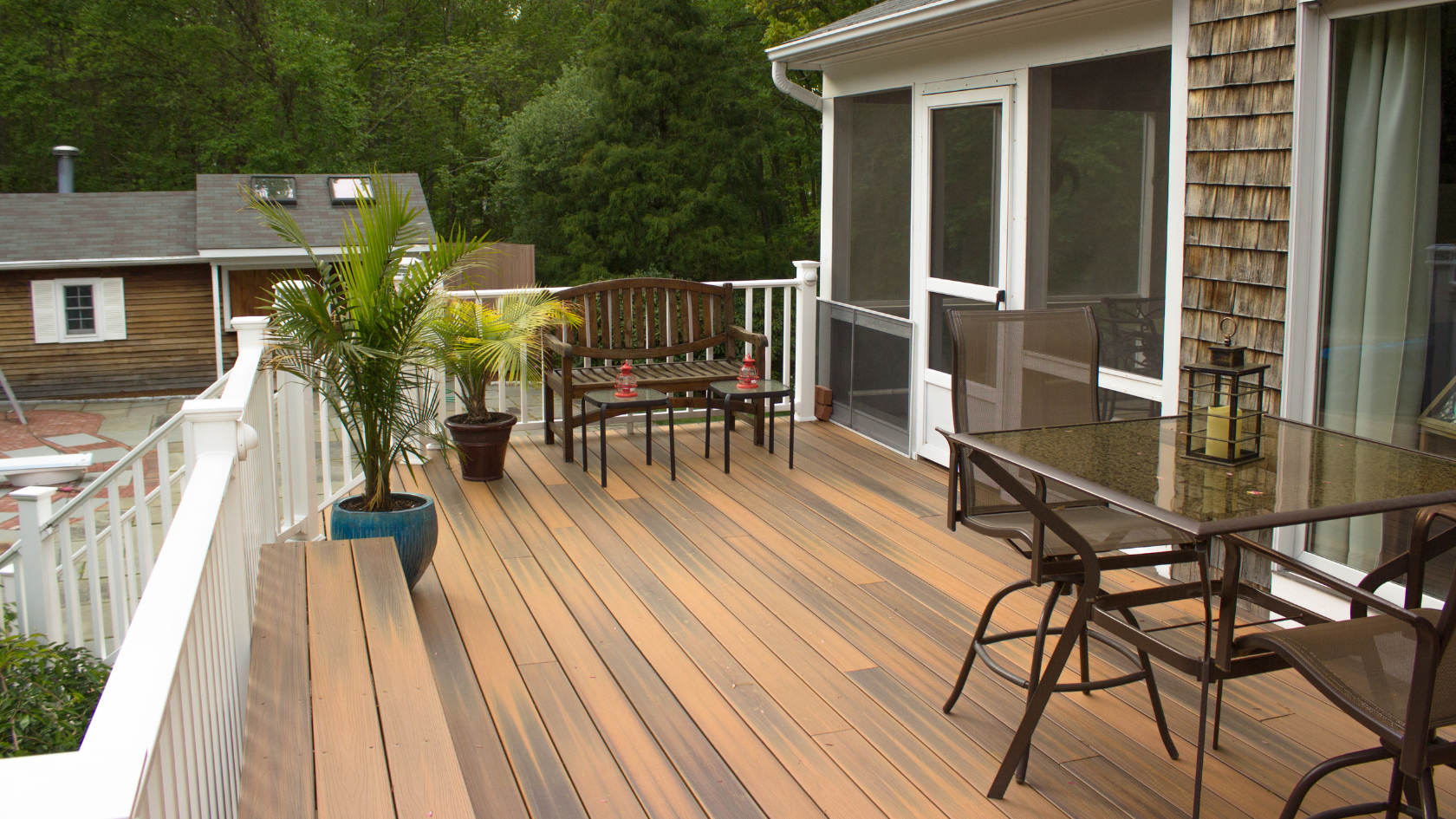 A wooden deck with chairs and a table on it