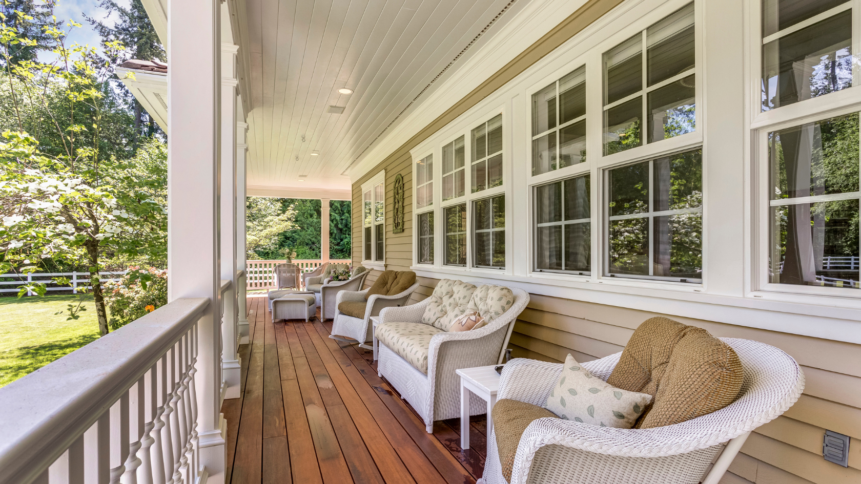 A porch with chairs and a table on it