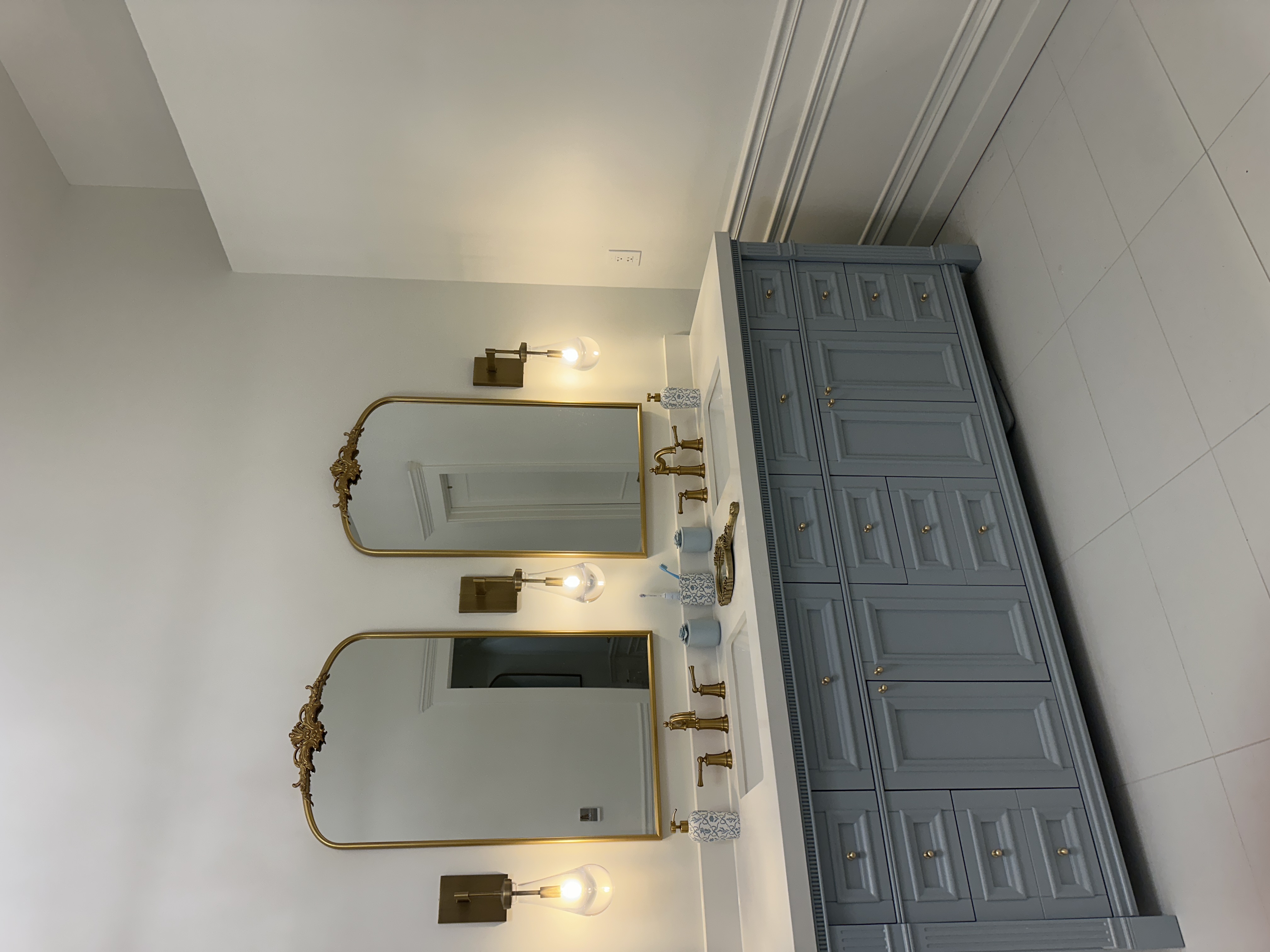 Finished blue-gray bathroom vanity with detailed trim