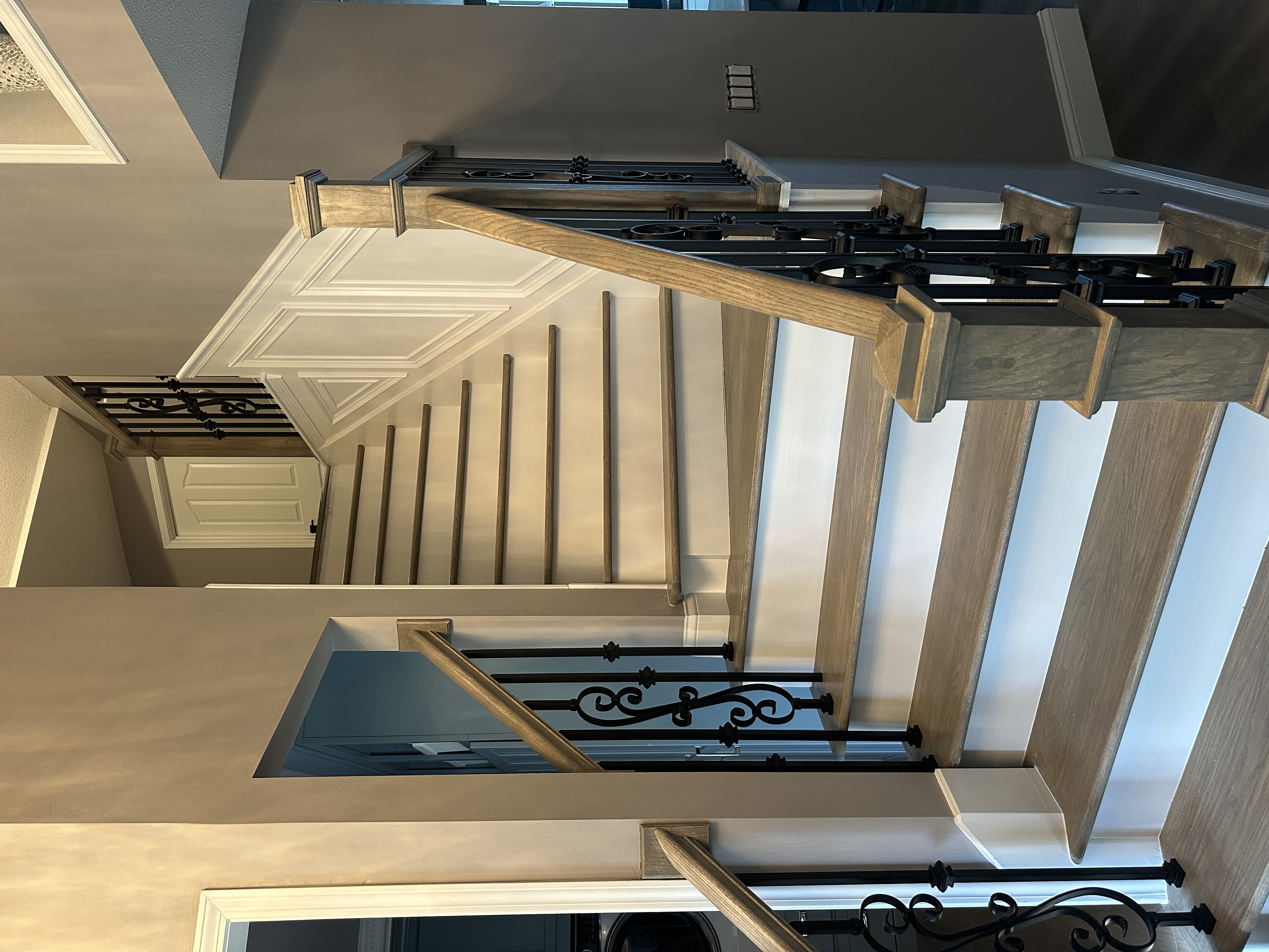 Finished staircase with detailed trim and railing